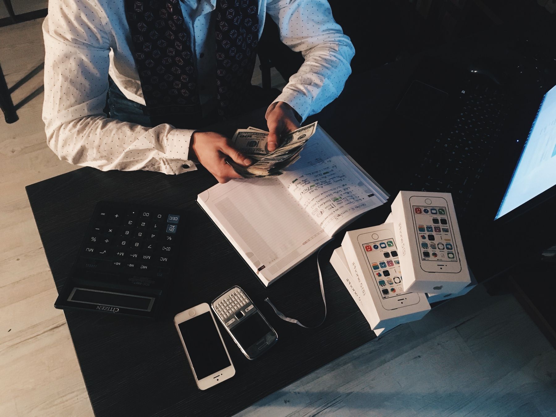 A bookkeeper writing notes at a desk